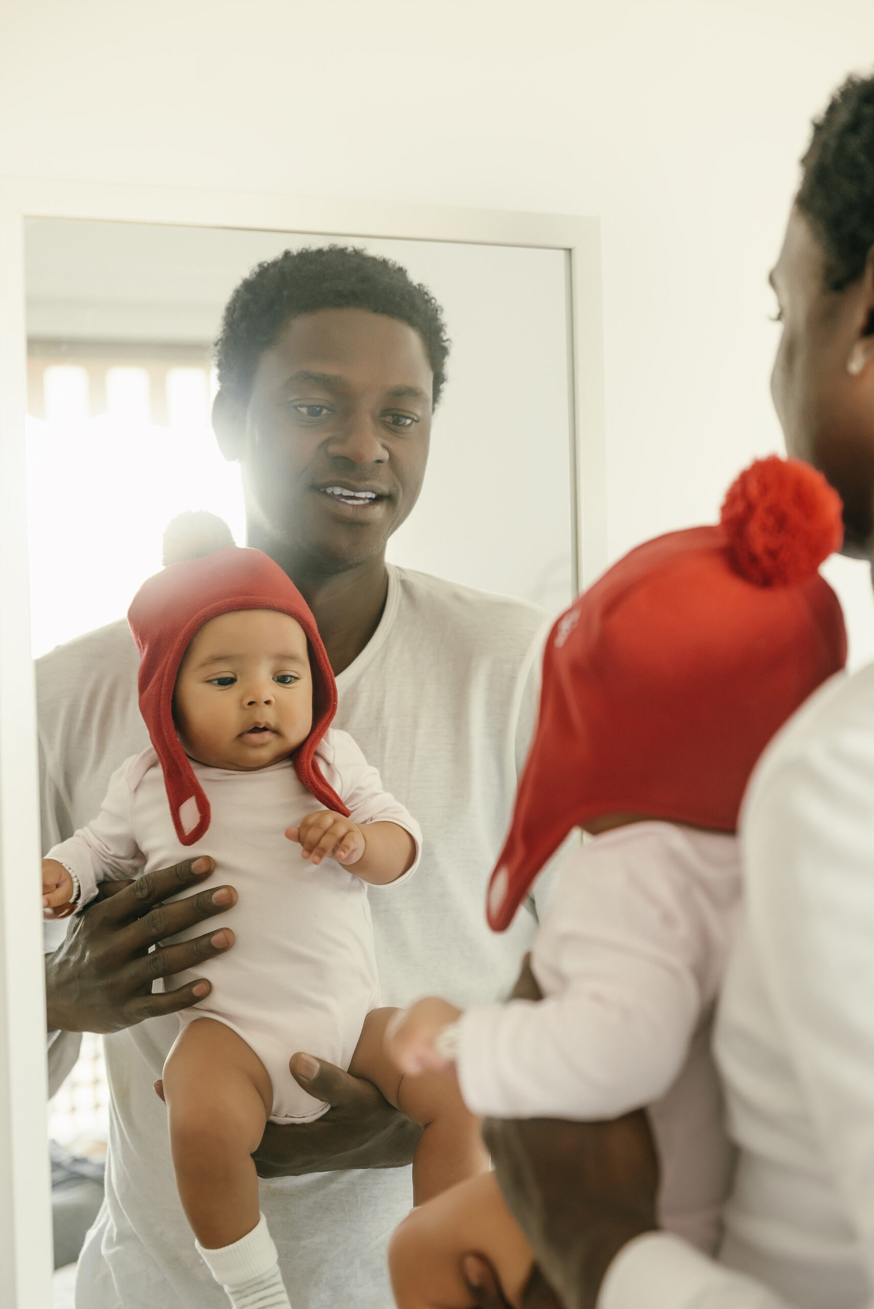 Cute Baby Girl and his father reflect in the mirror.Family concept