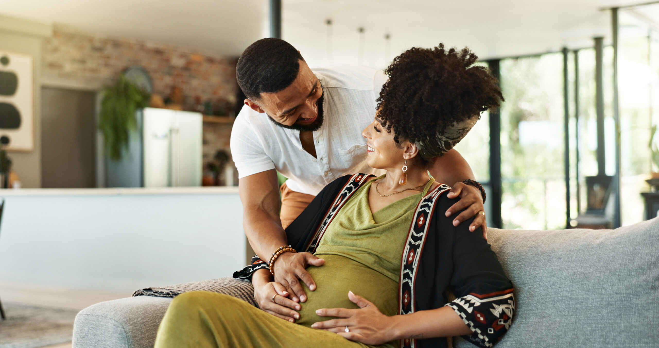 Pregnant, couple and woman in home with bonding, tummy touch and support with maternity and motherh.