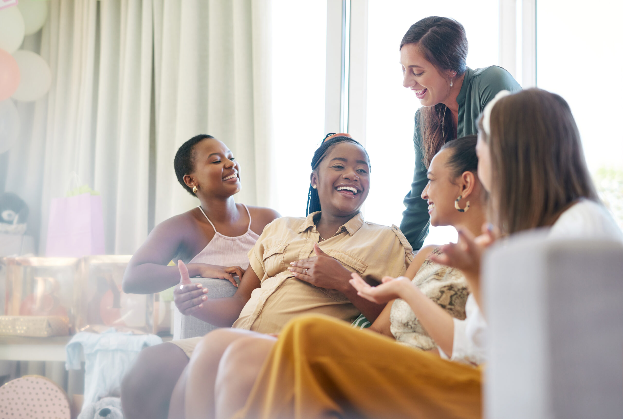 Im so excited to meet them. Shot of a group of friends relaxing together during a baby shower